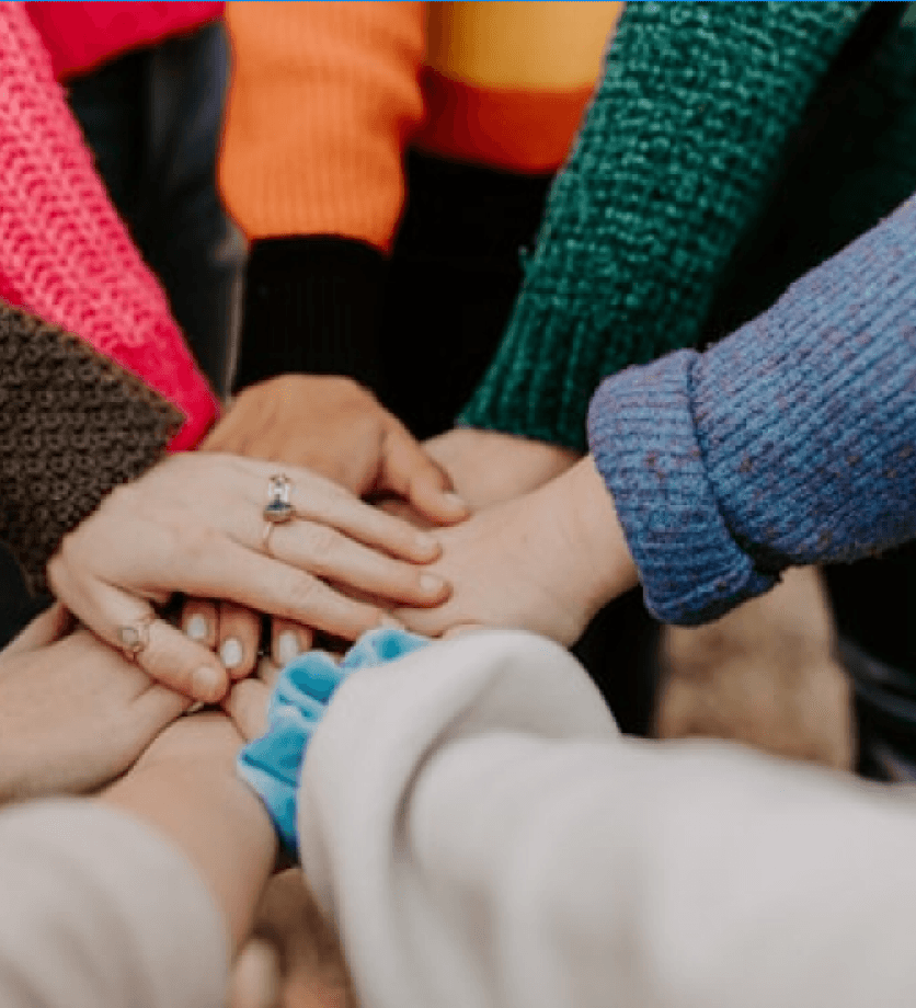 People joining hands together in unity